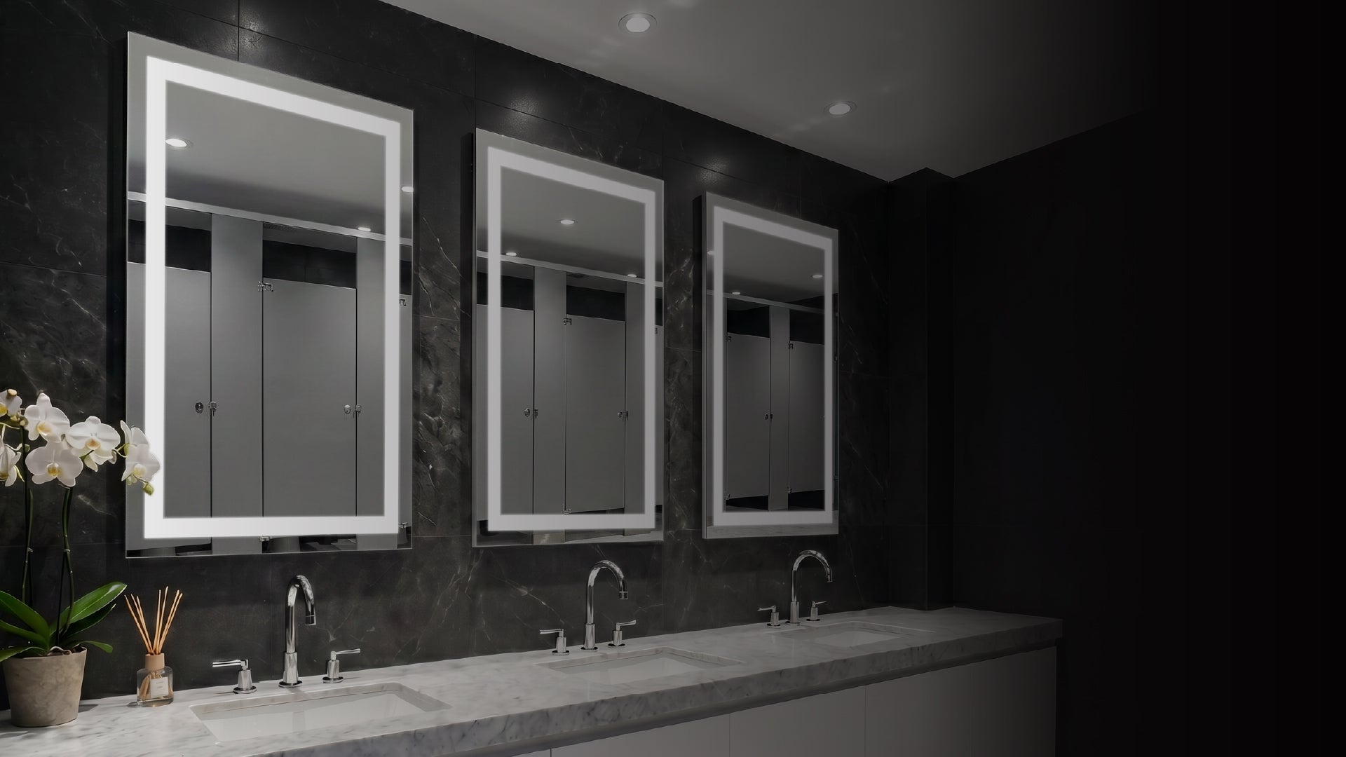 Bathroom with three mirrors on a dark wall, featuring a sink and decorative elements.